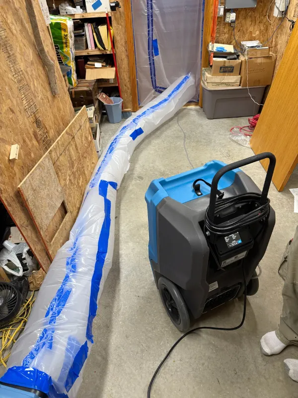Air mover drying a basement storage area after a water loss