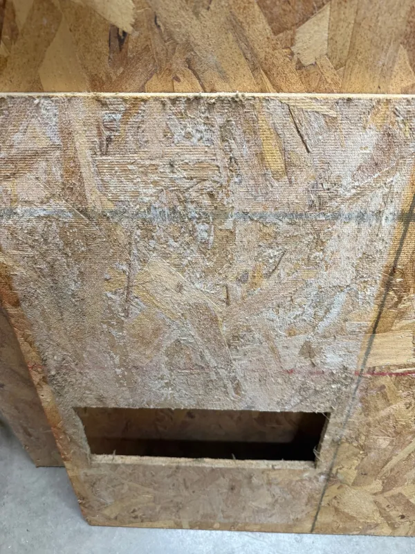 Access opening cut in attic sheathing to reach the work area