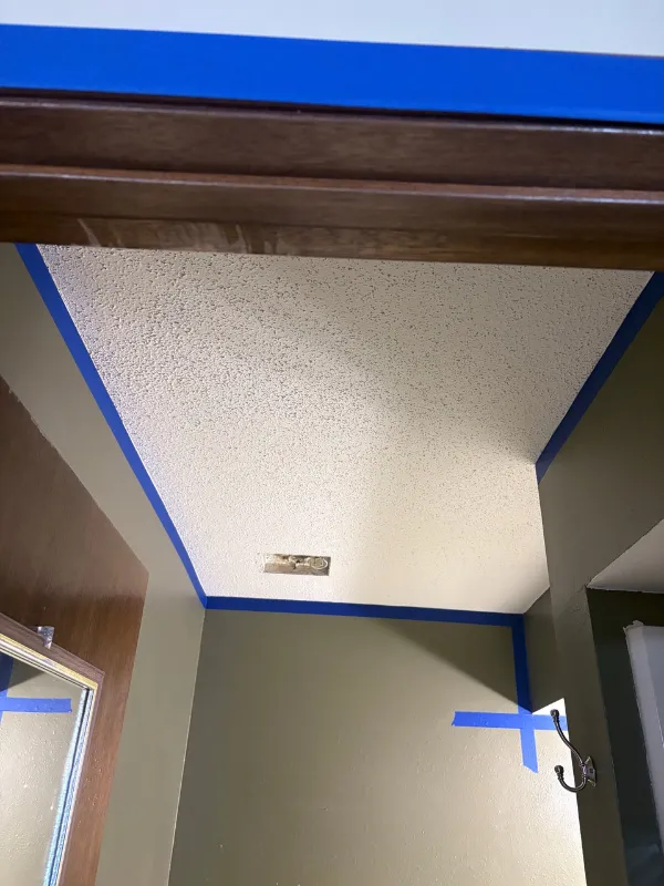 Ceiling and wall masked and prepped for repainting after repairs