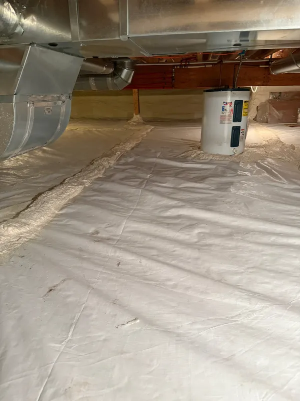 New vapor barrier and dehumidifier ducting installed in a crawl space