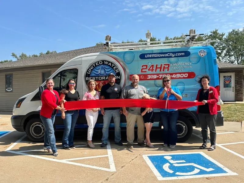 Staff gathered for the ribbon-cutting across the company van
