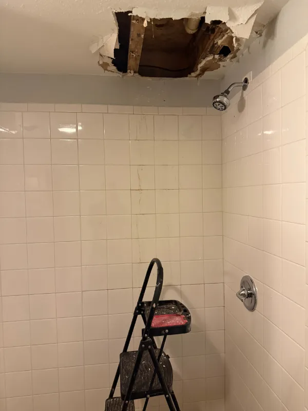 Tile shower stripped back for repair after a hidden leak